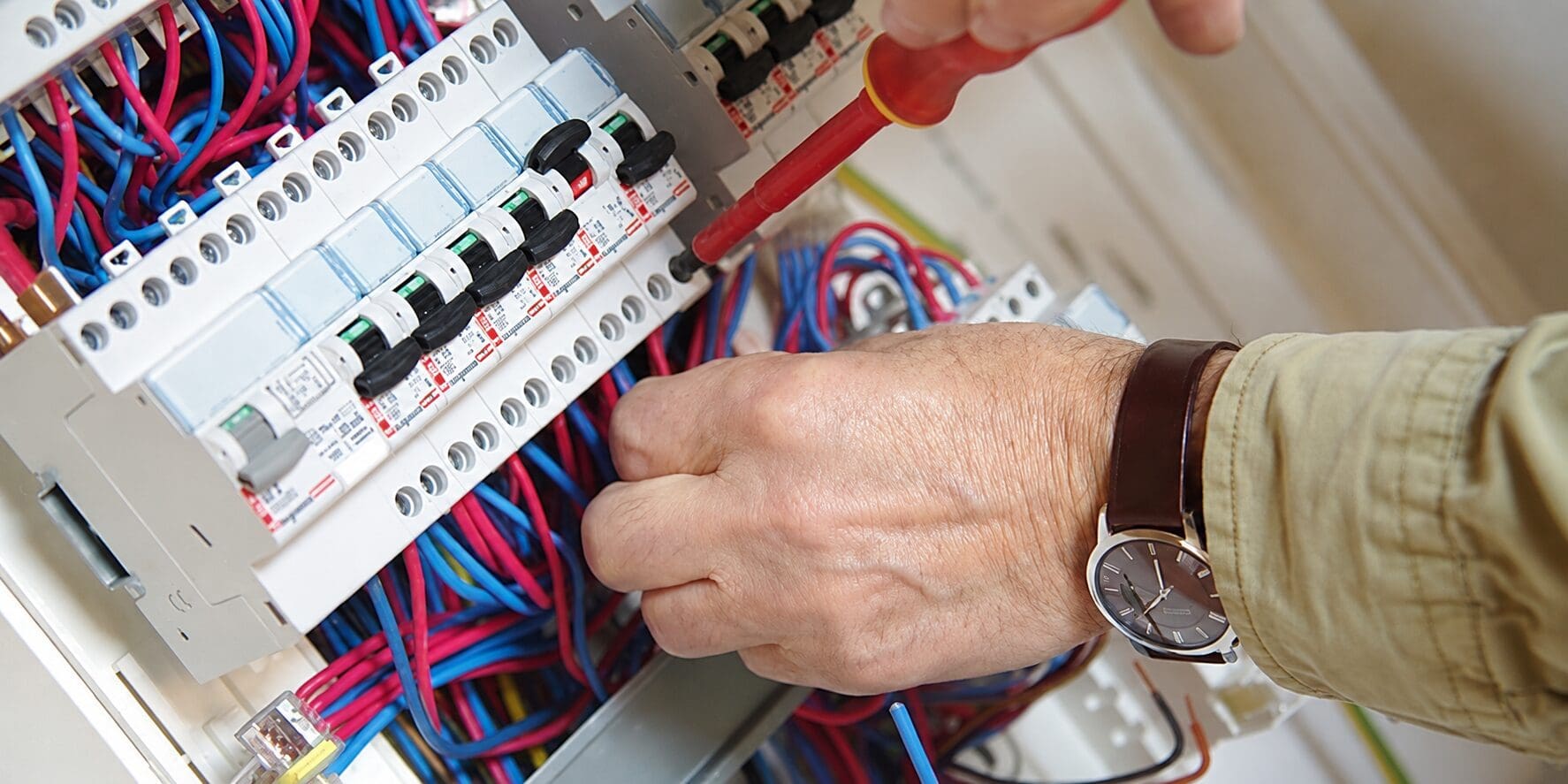 hands working on consumer unit